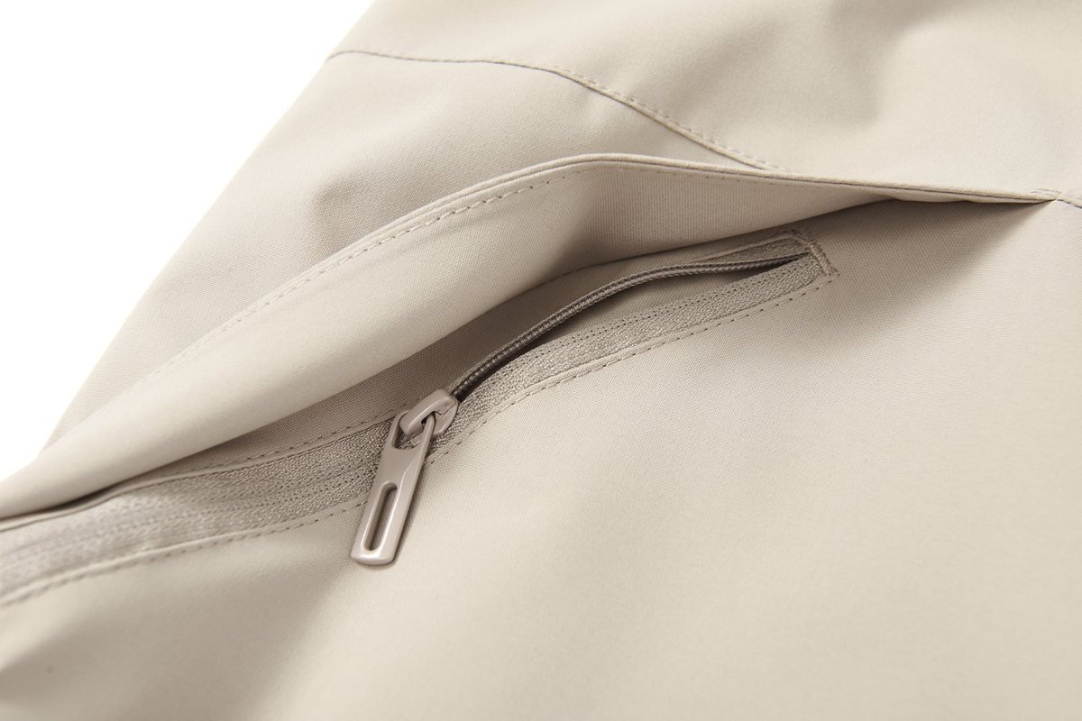Zip chest pocket on a cream shell jacket - 4-Way Stretch Softshell Fabric: What Brands Need to Know