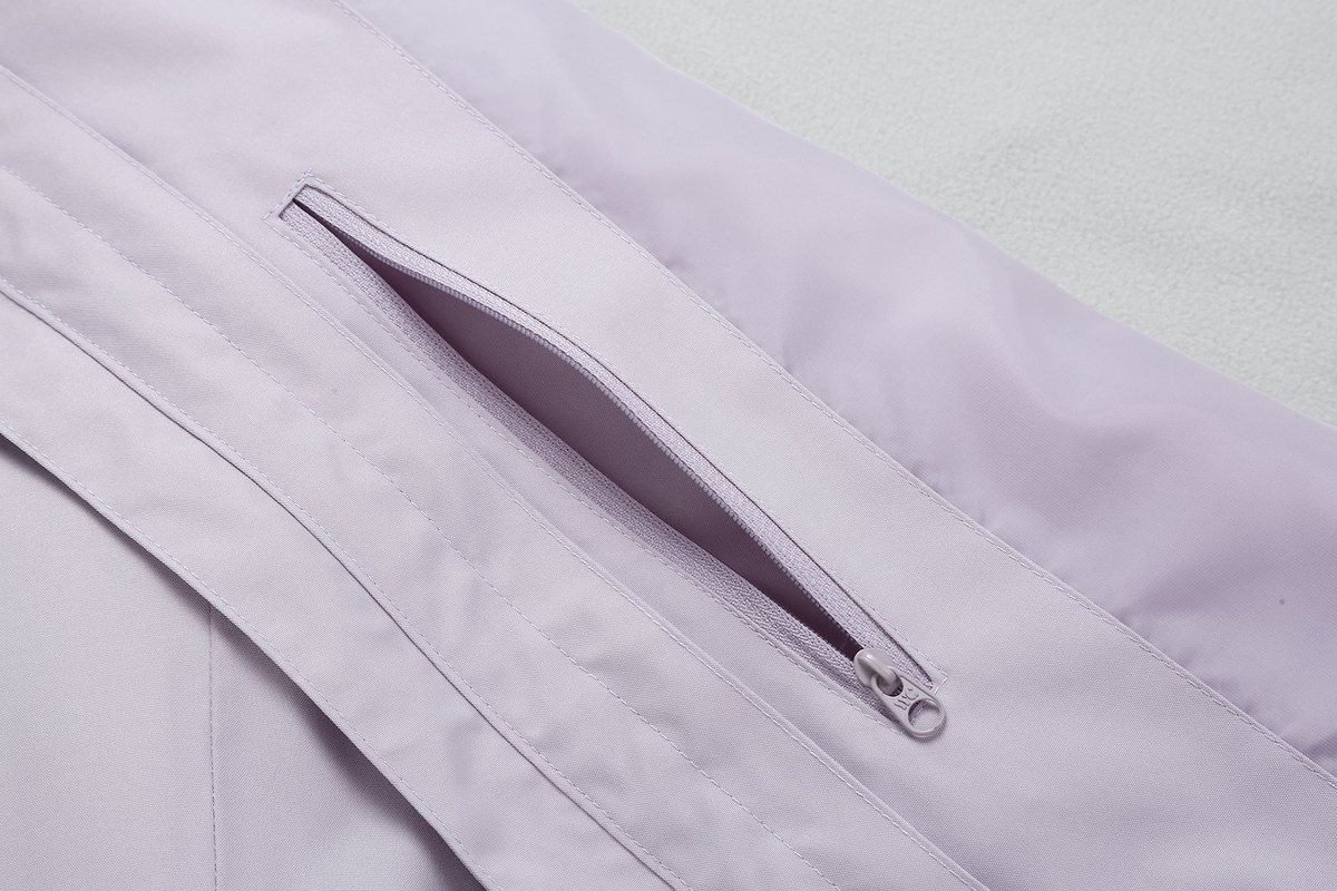 Welted zip chest pocket on a lavender shell jacket - Custom Logo Jackets: Embroidery vs Heat Transfer vs Sublimation vs Laser