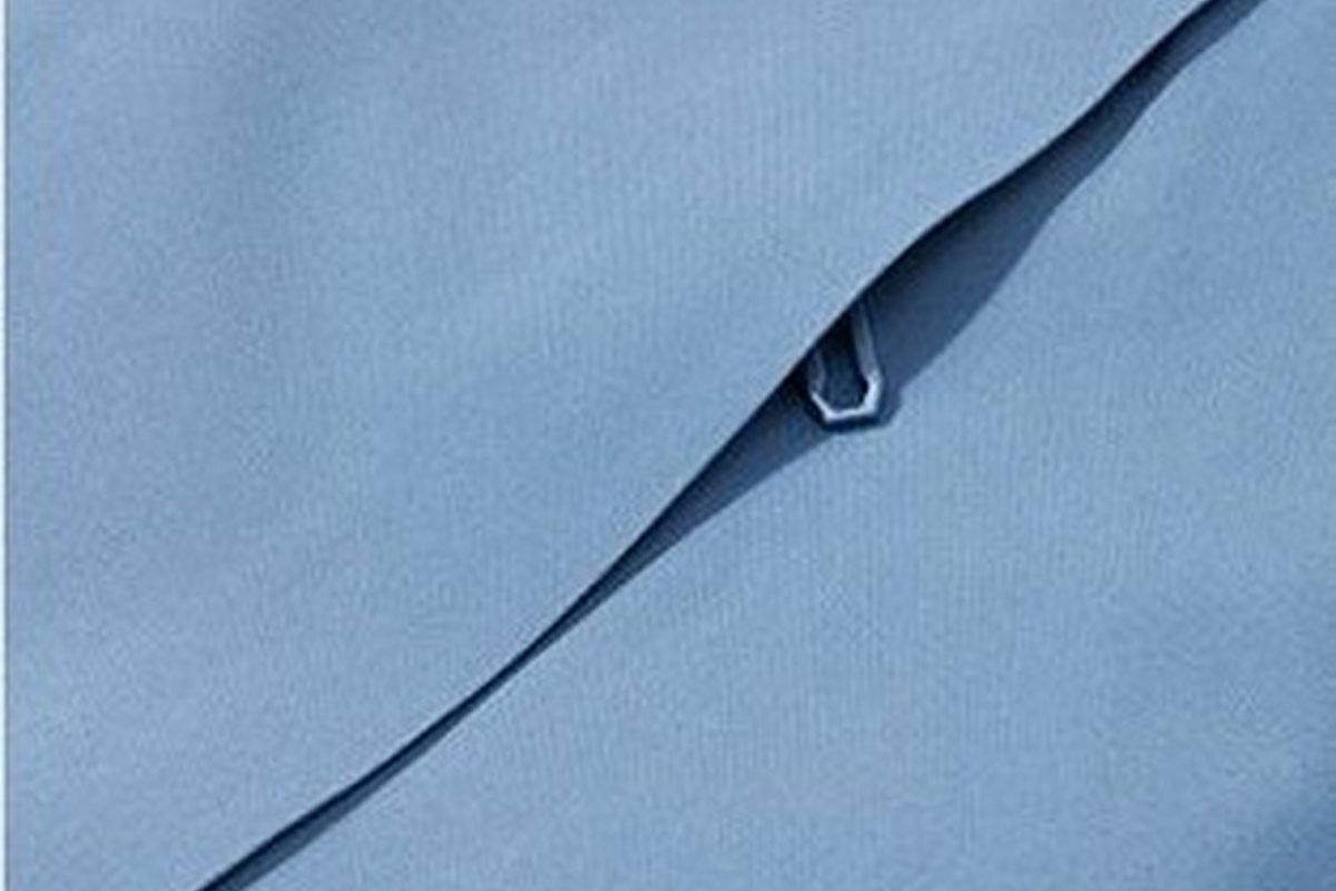 Laser-welded zip pocket on a light blue softshell - ePTFE Membrane Explained: How It Works and How to Source It