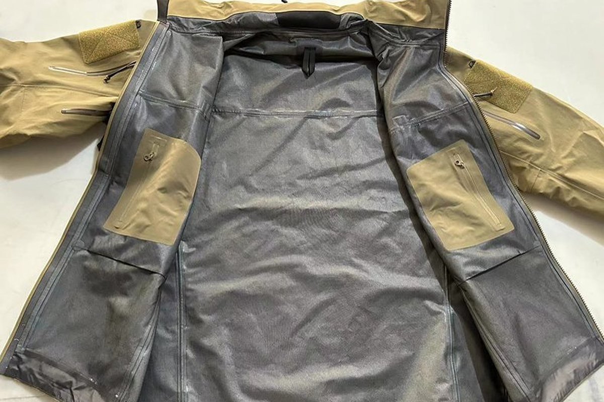 Khaki shell opened to show fully taped seams and membrane backing - Fully Taped vs Critically Taped Seams: Which Does Your Ja