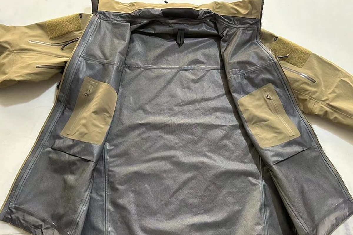 Khaki shell opened to show fully taped seams and membrane backing - Heat-Sealed vs Bonded vs Stitched Seams: Construction Com