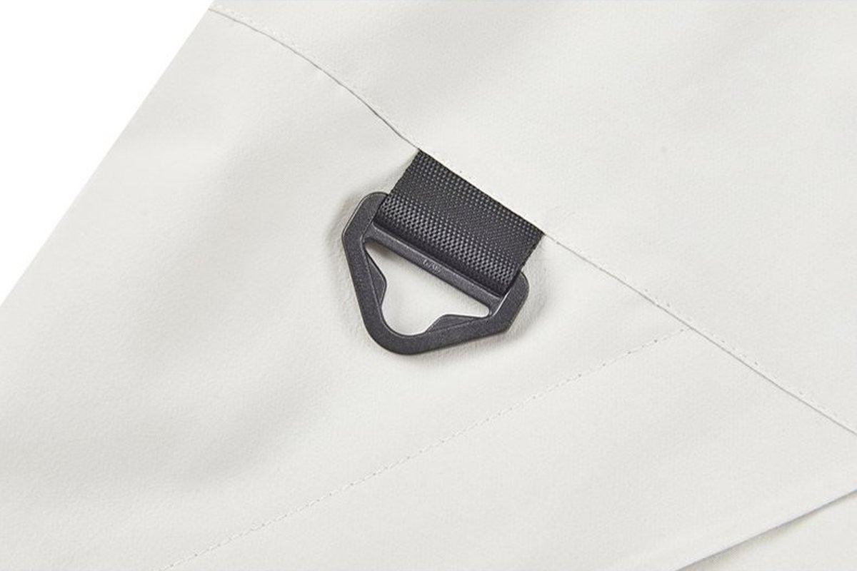 Moulded hanger loop on a cream technical shell - High-Density Embroidery Jacket Logo: 2026 Guide for Outdoor Brands