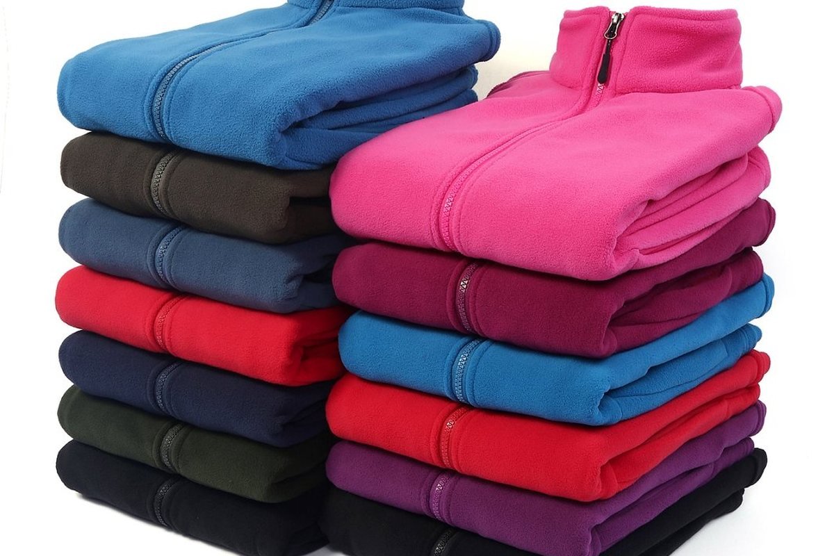 Stacked fleece jackets from a finished production run - Private Label Outdoor Clothing: B2B Sourcing Guide 2026