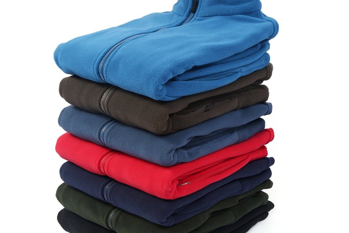 Production run of fleece jackets stacked by colour - Technical Dog Outerwear OEM: The Private-Label Sourcing Process for a Pr