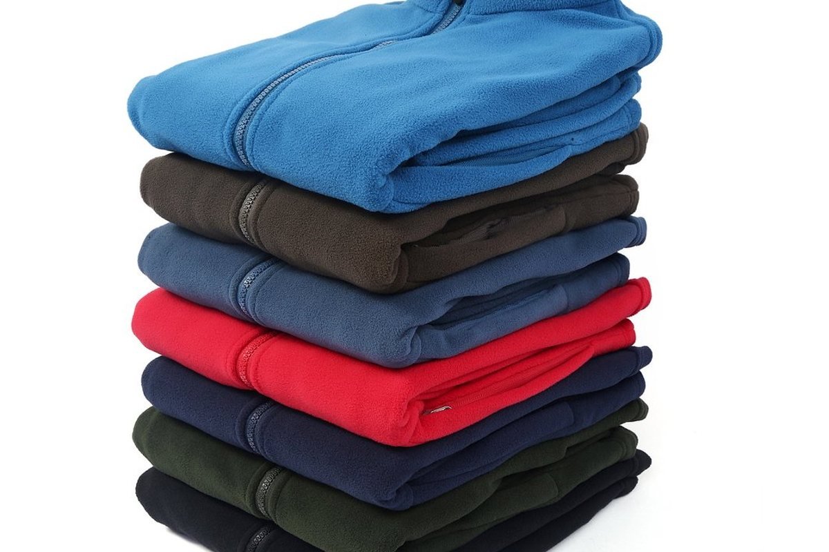 Production run of fleece jackets stacked by colour - Technical Outerwear Manufacturer: Performance Apparel Guide