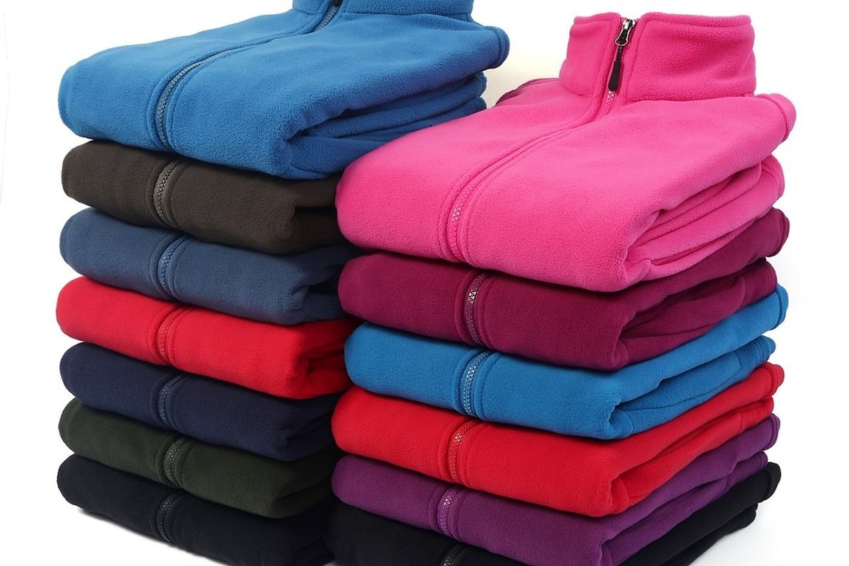 Stacked fleece jackets from a finished production run - Toray Dermizax Membrane Jacket Manufacturer (2026 Guide)