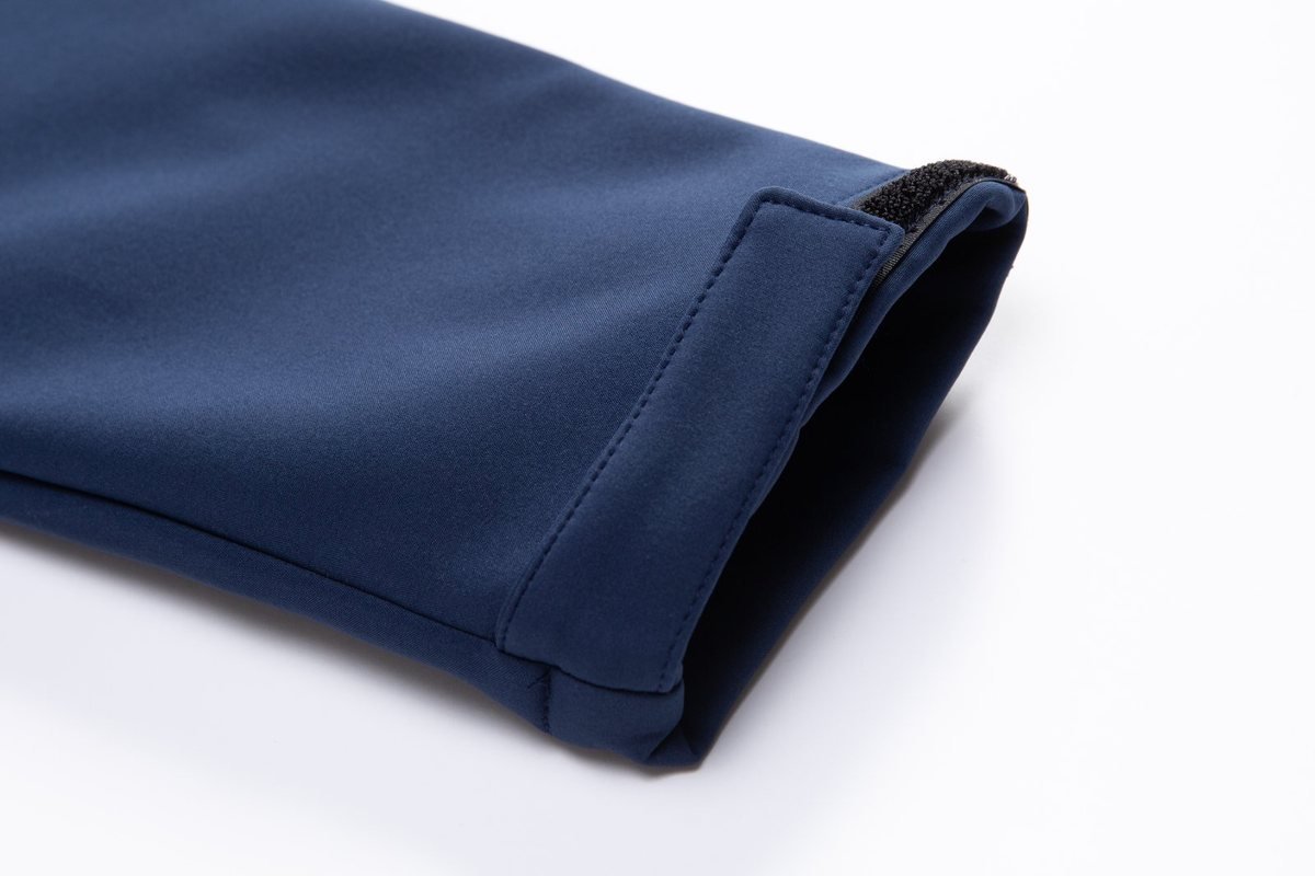 Bonded cuff on a navy softshell jacket - What Is a Membrane Jacket? (2026 Technical Guide)
