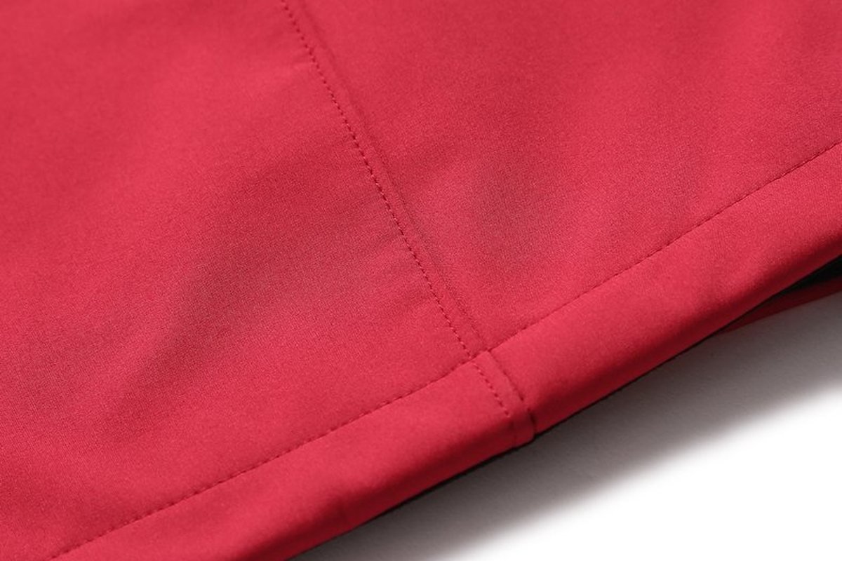 Hem of a red softshell jacket - What is PBT Fabric? Properties, Performance, and Outdoor Applications