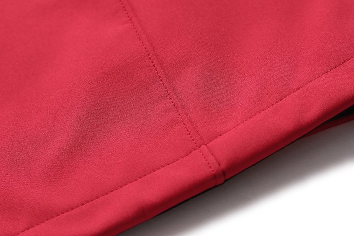Hem of a red softshell jacket - What is Polyamide Fabric? Properties, Skin-Safety, and Outdoor Uses