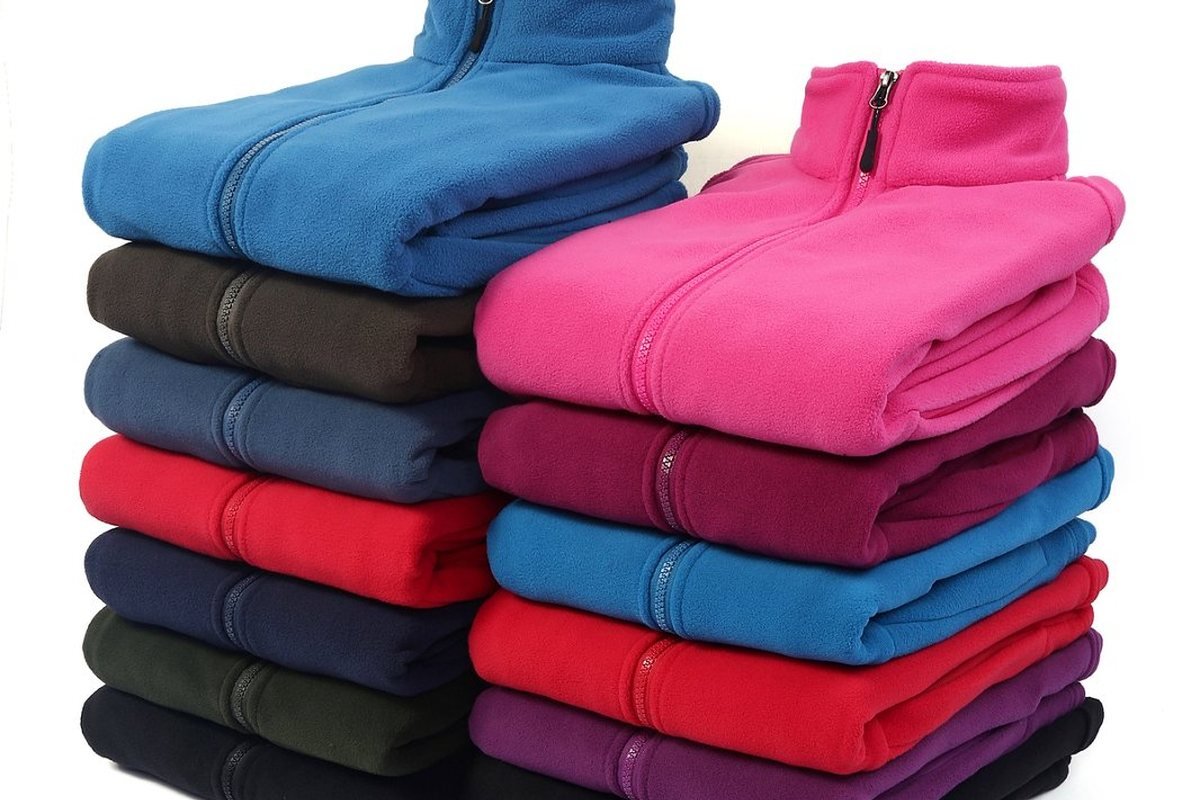 Stacked fleece jackets from a finished production run - Wholesale Outdoor Jackets: B2B Sourcing Guide 2026